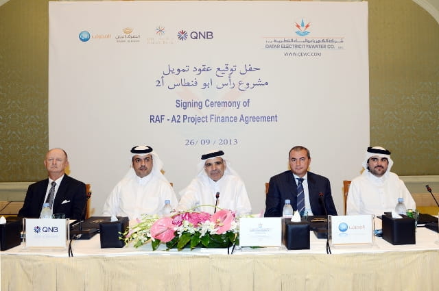 Photo showing finance agreement signing between two organizations.