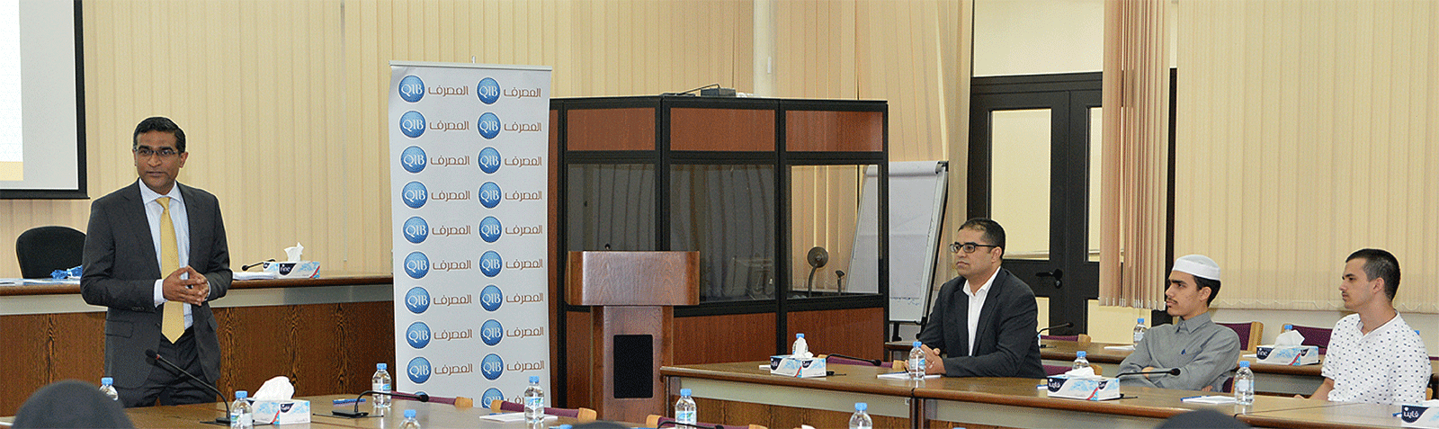 Banner showing financial education session at a university.