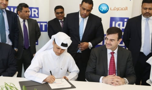 Photo showing a signing ceremony between banking institutions.