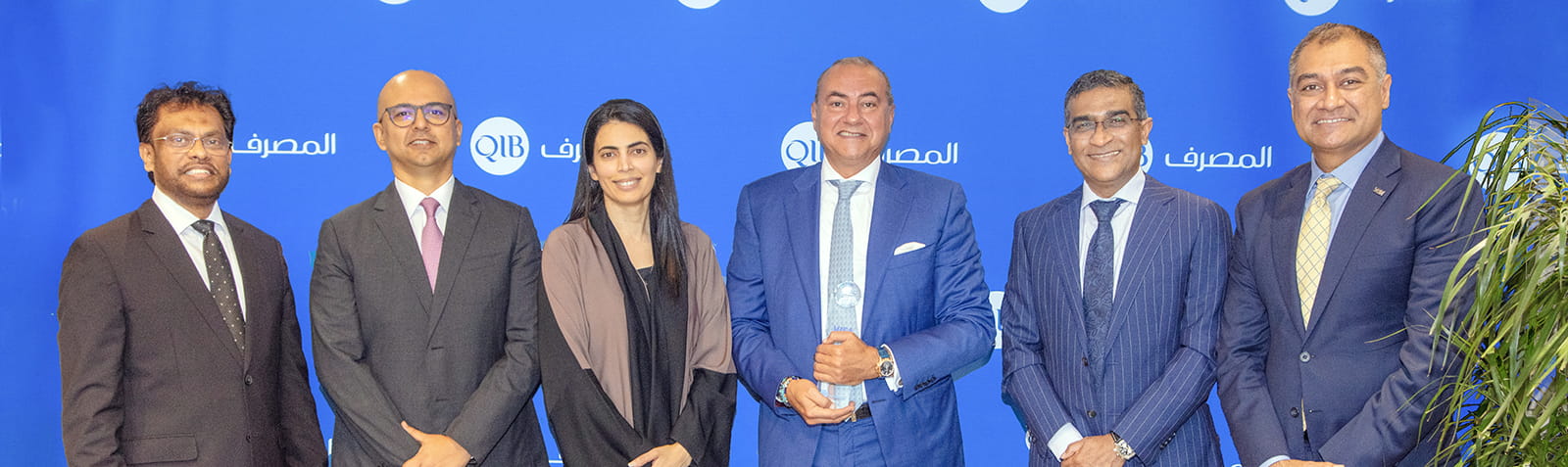 Banner announcing sustainability award recognition for banking performance in Qatar.