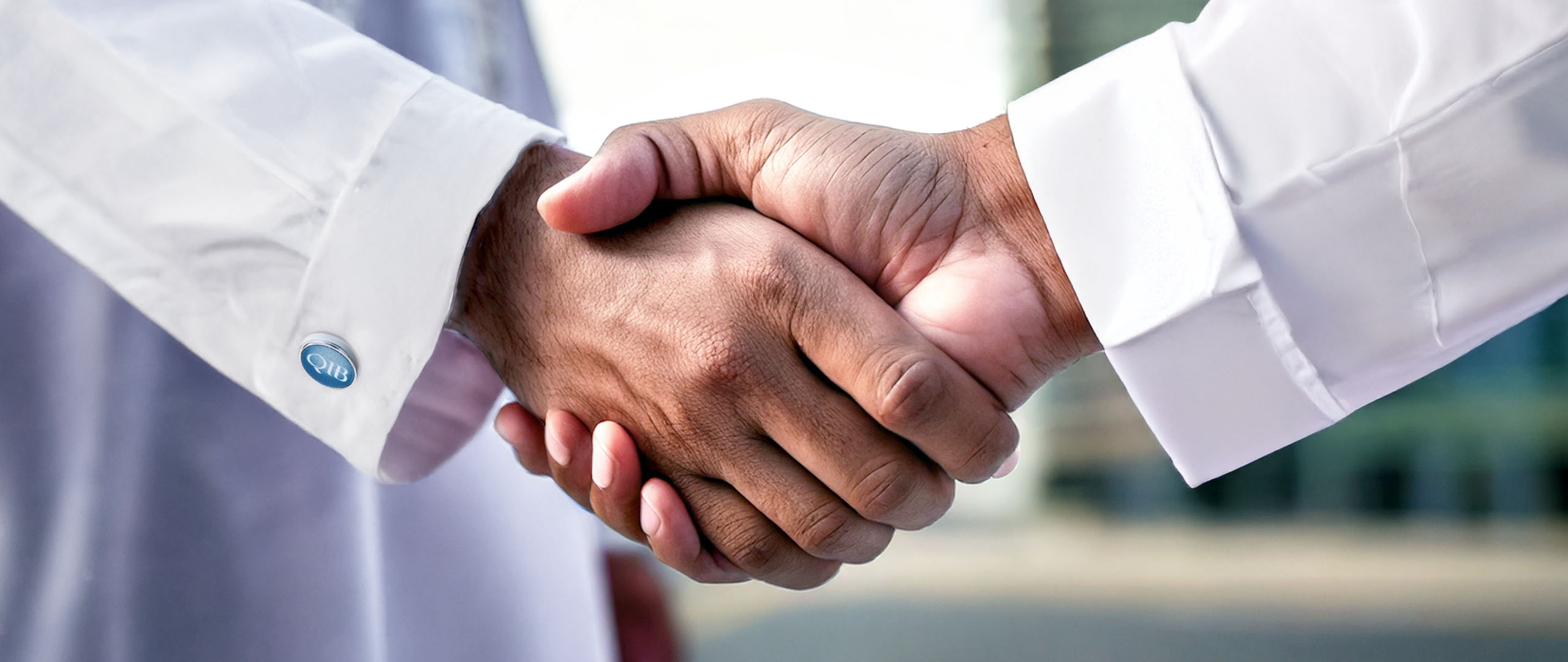 Handshake close-up between two professionals representing agreement or confirmation.