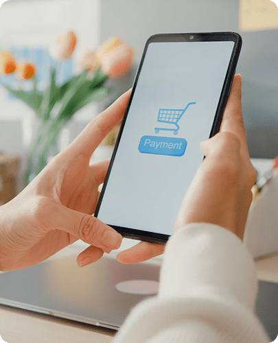 Person using a smartphone while preparing to visit a QIB branch as part of the Walady Education Plan process.
